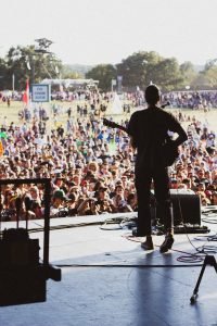 Performer on stage at festivals in the Highlands 